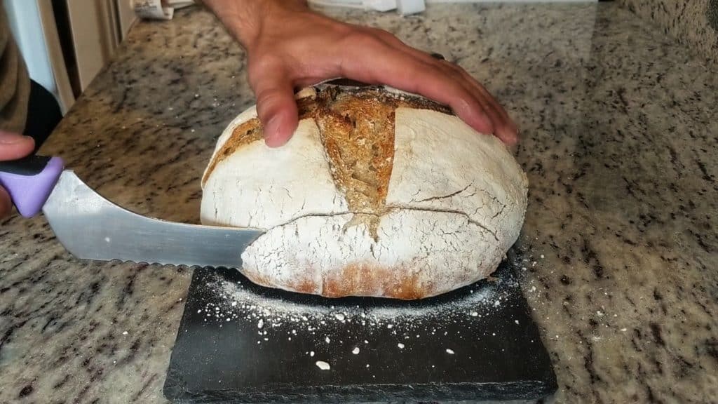 Slicing into my easy no-knead sourdough bread